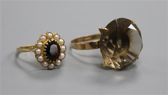 A 9ct gold and smoky quartz dress ring and a 9ct gold garnet and seed pearl oval cluster ring.